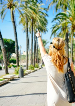 girl pointing at palm tree