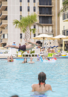 person jumping into pool